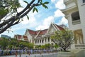 A line of Thai university student getting ready for graduation ceremony day at in front of a historical building.